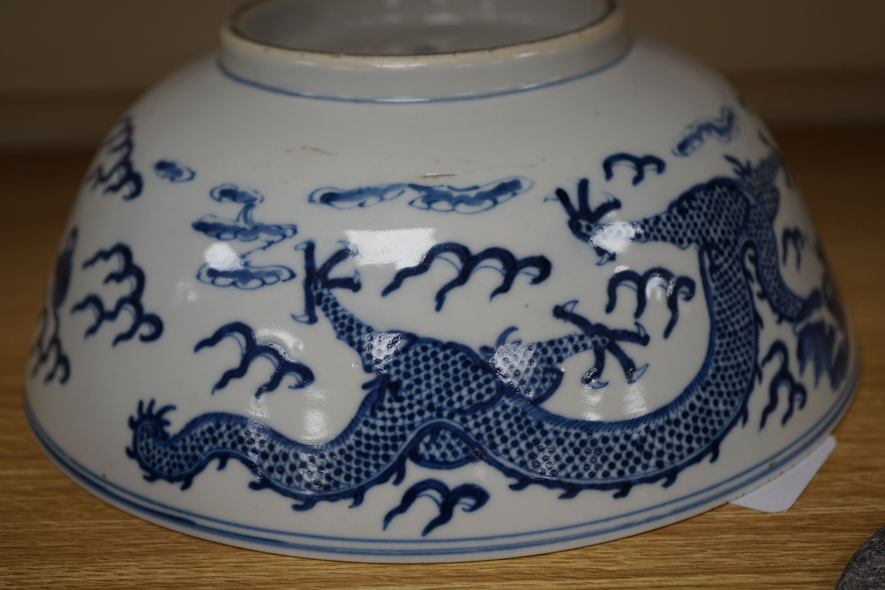 A Chinese blue and white ‘dragon’ bowl, Kangxi mark, late 19th century 25cm